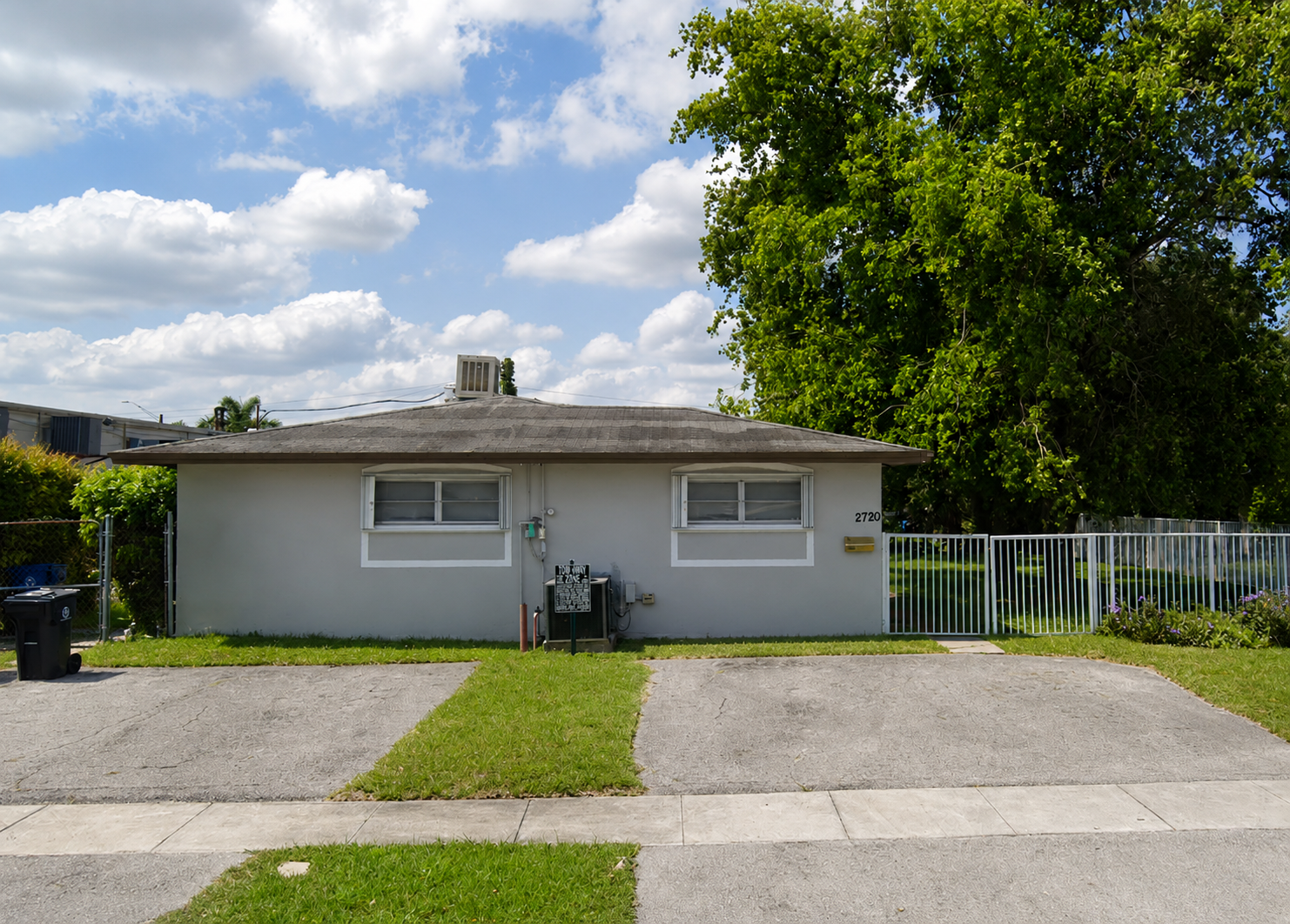 a_wide_straight_on_daytime_exterior_photo_of_a_sm
